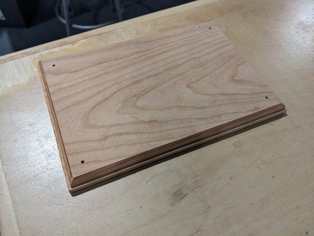 “Image of the wooden base of the Watts Water Plaque, unstained”